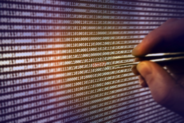 Image of a code and hands extracting data